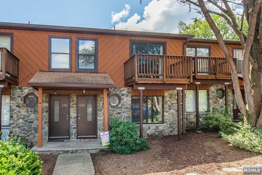 Welcome to Unit 13H, a charming and modern townhouse nestled in Wanaque. This thoughtfully updated home offers a perfect blend of comfort and contemporary style. The well-appointed kitchen features new stainless steel appliances, quartz counters, light colored cabinetry with a breakfast bar and a coffee bar. The open floor plan creates a seamless flow between the living, dining, and kitchen spaces, perfect for both daily living and entertaining. The sunken living room adorns a gas fireplace with a floor to ceiling marble surround and sliders to one of two decks. Upstairs, you'll find two bedrooms with two bathrooms along with new flooring throughout. The primary suite is a retreat in itself, with dual closets, a private deck, en-suite bathroom for added convenience. The finished basement is a perfect bonus space for an office, playroom or family room. Enjoy the convenience of the amenities along with a community pool while still savoring the privacy of your own home.