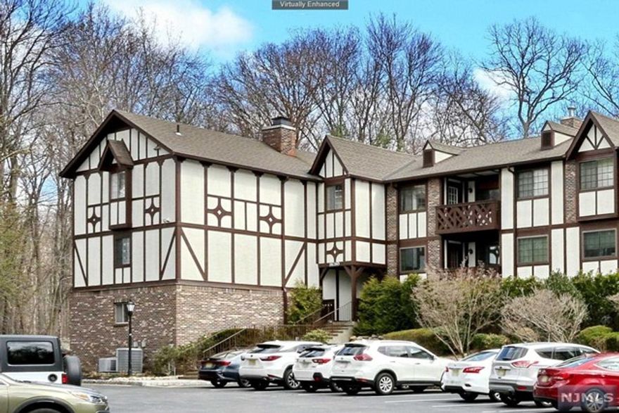 This is the one you have been waiting for! Premier location unit featuring 2 bedrooms (plus an additional den area) and 2 full bathrooms in the wonderful Ridge Gardens community. Updated kitchen with granite counter tops, under cabinet lighting, stainless appliances, breakfast bar and huge pantry. Formal dining room with crown molding and access to a private deck overlooking a beautiful, serene wooded area. Large primary bedroom suite with a walk-in closet and full bathroom with stall shower and tub. The second bedroom has a walk-in closet, Jack & Jill bathroom to hallway with lots of closets and washer/dryer. One car over-sized garage (#4) with new electric eye opener plus easy access to a large storage unit. Great low Mahwah taxes, tons of parking, pool, tennis and water included in maintenance, on site management. Relax on the deck looking at the beautiful woods, one floor living at its finest!