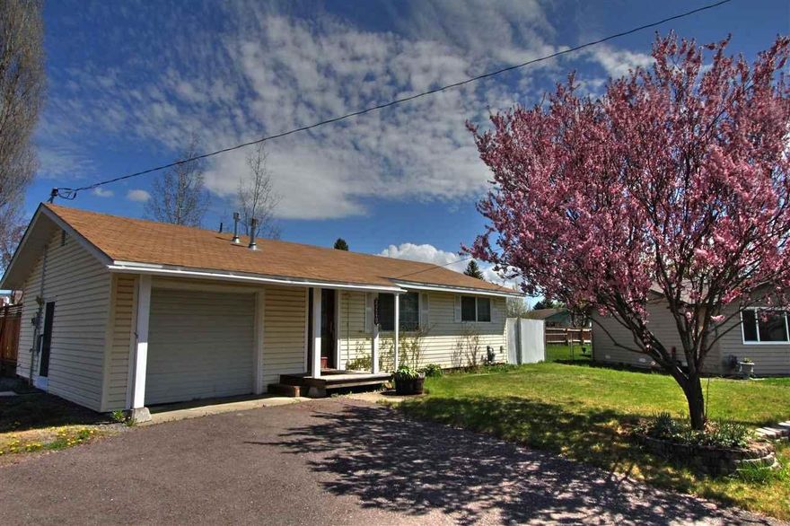 Fabulous 2 Bedroom, 1 Bath Home Situated In Suburbs On A Cul-de-sac. Hardwood Floors In Kitchen And Dining Room, Tiled Counter Tops. Knotty Pine Cabinets, Double Sink, Track Lighting Plus Sliding Glass Door In Dining Area That Exits To Large Wooden Deck And Fenced Backyard. Addition Sliding Glass Door In Bedroom. Ceiling Fans In Living Room,Both Bedrooms And Dining Room. Utility Building On Blocks With Electricity, Large Dog Run /Dog House Or Could Be Additional Storage. Large Fenced Back YardRv Parking Area, Compact Attached Garage.