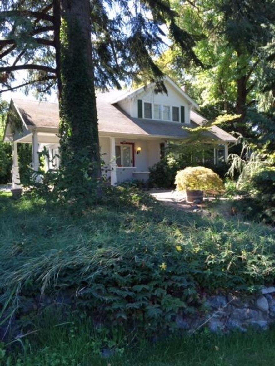 Fabulous home secluded in it's own park like setting! Garden area, six fruit trees; many decorative trees, water feature and screened in back porch all on .80 acres! Only a bike ride or walking distance to downtown Grants Pass. Beautiful two story home with a full basement. Home remodeled in 2003 and more improvements in 2006. Top of the line appliances in the kitchen. A warm and inviting sunroom that overlooks the large plush front yard. There is a bonus play house and a separate guest house. District 7 schools. This home has so much to offer!