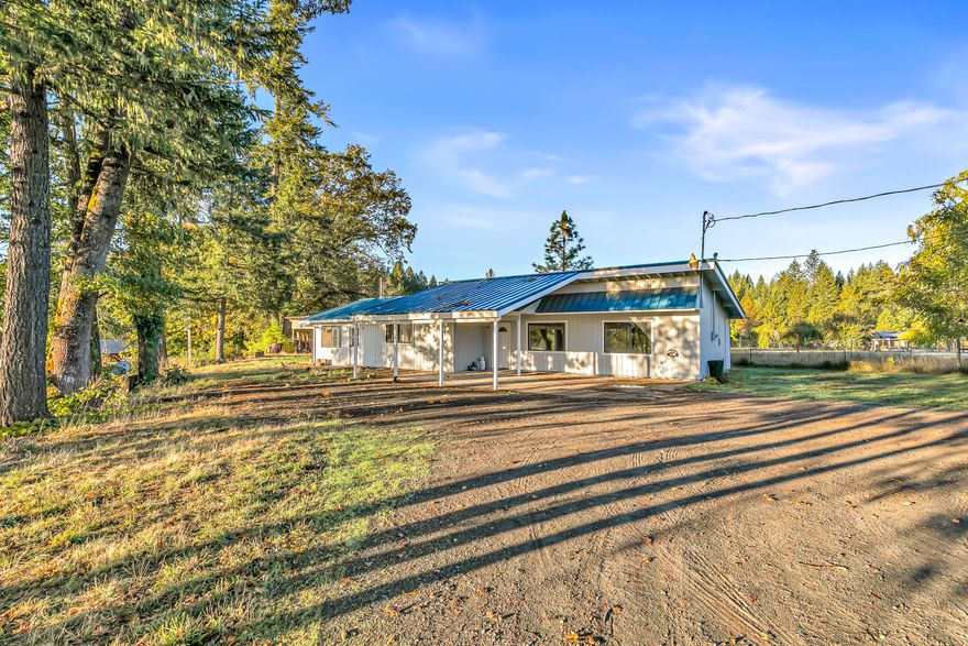 Looking for a low maintenance ranch property at an affordable price? If so, this is the one for you! Within 10 mins from downtown Cave Junction, this property features a single level, 3 bedroom, 2 bathroom, 1570 sq ft home w/ a metal roof, walk-in closet in the primary bedroom, walk-in shower, walk-in pantry, woodstove in the living room, spacious kitchen, laminate flooring, and various touch ups throughout. For anyone interested in farming this property also features 5+ usable acres (all pasture), detached shop (27x30), detached 2 car garage, pole barn, gated entryway, & much more! Perfect opportunity for anyone wanting to raise their family in a beautiful Southern Oregon setting while starting a farm on a small or large scale. This one won't last long on the market, so contact your agent today for a personal tour, before it's too late!