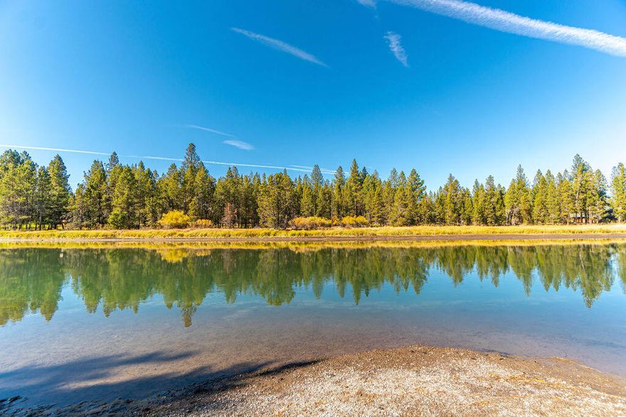 Come, build your dream home on this RARE riverfront lot WITH ACCESS to the Big Deschutes River. Fish, kayak, float or paddleboard right from the gently sloped, sandy bank of your own back yard. One of the last remaining buildable river view lots in all of Bend - FLAT over ½ acre, beautifully treed and partially cleared! Serenity awaits in the desirable OWW2 quiet neighborhood with own private marina and 40 acres of National Forest with trails.  Unbuildable land across the river provides UNOBSTRUCTED VIEWS of nature and wildlife, plus vacant wooded lot on one side owned by neighbor provides privacy buffer. Paved street with no through traffic, away from busy corridors. VERY QUIET & PEACEFUL! Community has sewer and water available, electricity at the street. Snow removal covered by HOA, no ARB. Enjoy the rural character of the neighborhood with low HOA fees. Close to Sunriver, Mt. Bachelor & Cascade Lakes. Don't miss this RARE OPPORTUNITY on the BIG DESCHUTES! Lot Dimension is 80X257.