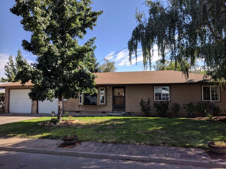 This Central Point home has a lot to offer! Starting with 1288 sq. ft and 3 bedrooms and 2 bathrooms. As you enter this home you will notice the hardwood floors flow throughout the house. There is a large living room with a fireplace. The kitchen is large and offers plenty of counter and work space. Master bedroom has doors leading to the paved patio. Outside you will find a huge raised bed garden but much potential is left. There is a detached shop that can have multiple uses. The great thing about this home is the attached two car garage has a pull through to get your toys or boat to the shop located directly behind the home.