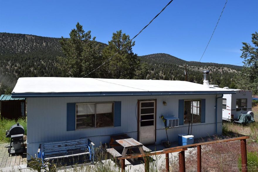 Eagles soar from the gorgeous rock cliffs which tower close to this beautiful 2.82 acres. Home is just minutes to the Prineville Reservoir for fishing and boating activities. This could make a great get away, vacation cabin as a 2 bedroom, 1 bath MFG home approximately 864 sq. ft. Investors take note, with rentals being in such short supply in Central Oregon. Cash buyer only due to age of home. Check out the world class outdoor activities of Central Oregon. BLM is very close by.