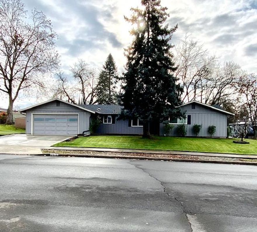 Charming home in desirable East Medford on a large .25 acre lot w/ RV Parking! This quaint 3 bed, 2 bath home boasts 1324 sq ft of living space & many updates! Recent updates include interior paint, countertops, sink faucet, garbage disposal in kitchen, stainless steel appliances in kitchen, updated bathrooms, new LVP flooring, newer HVAC as of 2018, newer roof installed in the last 5 years, new poured concrete driveway apron, inground sprinkler system in front/ rear on timers, exterior paint as of 6 years ago, & new gutters! This home has ample sized rooms throughout, cozy wood burning fireplace in the living room, lots of large vinyl windows for plenty of natural light & still room to add your own personal touches. The large fenced in, landscaped lot this home offers makes this home perfect for outdoor activities w/ a covered wood deck & more, not to mention the RV Parking as well! This home won't last long! Schedule to see it today!