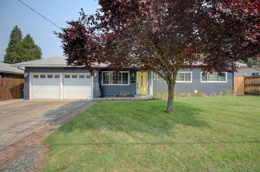 Updated cute & clean E. Medford home. Great floor plan for entertaining with the recent remodel to open the living room up to the over-sized dining room. This 3 bed, 2 bath home features oak hardwood floors, new carpet and closet doors, wood burning fireplace, newer interior and exterior paint, vinyl windows and ship-lap accents. Both guest and master bathrooms have been completely updated with custom vanities, white hexagon tile floors and subway tile shower surrounds. Brand new hot water heater and a dedicated laundry room off the garage. 2 car garage with a pass through feature that allows you easy access to your over-sized back yard and 12 x 16 shed.