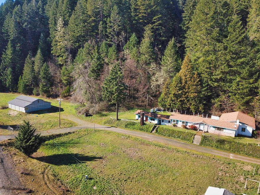 Great Opportunity! Fixer and a barn on 3.54 acres. Home is 3 bedrooms, 3 baths with 1716 sf plus an attached bonus room. Barn features 6 stalls, tack/feed room with saddle racks, office/bathroom. Easy to add turn-outs. Courtyard style back yard. Neighboring property at 9400 Redwood Hwy also available for possible 2 family set up.