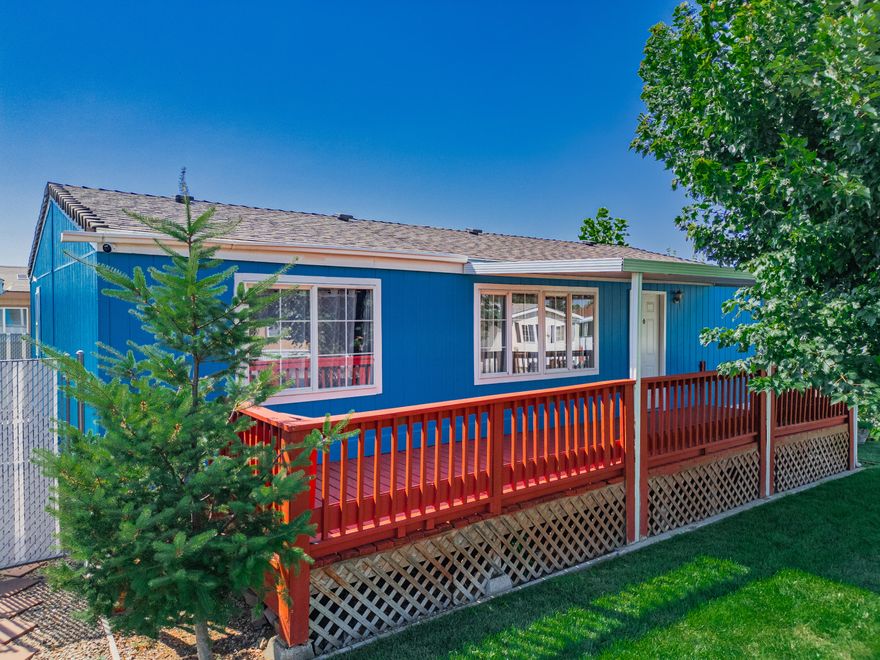 Step into easy living with this spacious 3-bedroom, 2-bath mobile home on a desirable corner lot! You'll love the incredible parking with two dedicated spaces out front and two more in the back, complete with a convenient carport. Enjoy relaxing on your front porch or spending time in the fenced backyard, which also includes a handy storage unit. Inside, you'll find sleek vinyl flooring throughout, and the washer, dryer, and refrigerator are all included, making this home truly move-in ready!