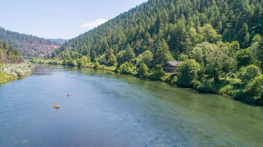 A Rare and Special Riverfront Retreat on the Scenic Rogue River. Disconnect and Retire to the Song of the River while watching Bald Eagles soar, Otters frolic & Ospreys dive for their dinner from your covered deck or inside, from the expansive river & mountain view windows. This is a premier fishing site located btw Ennis Riffle & Carpenter's Island. Private dock for easy river access.  Impeccably maintained home has room for your RV & extra cars with 2 separate garages. Lower level garage can fit RV & boat or 4 cars w/workshop area and ½ bath. Home has 1 bdrm, 2 full baths, 2 half baths, an open kitchen/living rm floor plan & 3 Spacious Bonus Rooms providing ample space for offices/hobby/etc. Primary bdrm has view windows, slider to deck, walk in closet & private bathroom.  Newer interior paint, Roof, HVAC, Water Htr & Appliances. Well maintained vinyl exterior. Home comes furnished & ready to begin your cherished memories. Ask to see: video tour, 360 tour, Feature List & Inspection.