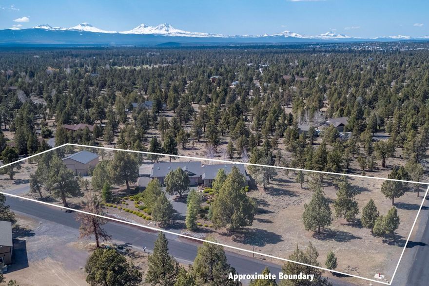 If you're looking for a bit more space and enjoy peace & quiet, take a close look at this spacious single level home sitting on an expansive 2.5 acres with open terrain views in every direction, as well as filtered views of the Cascade mountains! Located just outside of Bend, this home enjoys four bedrooms (3 suites) an office, laundry room and tons of extra space - including a 4 car garage + a 5th bay, that is heated.  As you enter the vaulted great room you are greeted by views out across the backyard - a stunning setting with multiple outdoor spaces to enjoy, including a pergola-enclosed dining area, hot tub, above ground fire pit, and a sitting area with push button awning. The primary suite is situated just off the great room with private westerly views, walk in closet and large bathroom - and has excellent separation from the guest suites. Out back there is a 40 x 40 shop that has 3 bay doors, including two 14' doors - perfect for all your outdoor toys.