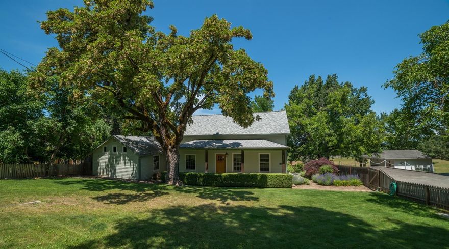 Historic home built in 1878 w/many newer updates! Home was built for the 1st doctor in Jacksonville, just blocks away from downtown. Lg .45 acre lot w/beautiful landscaping, lawn, tall trees, stone walk ways & nice views. Covered front porch. All wood floors throughout & tile floors in bathrooms. Open railing staircase in living & formal dining rm w/ brick gas log fireplace. Open kitchen w/ island, cherry cabinets, 5 burner gas cooktop, dbl ovens, Corian & butcher block counters. Vaulted ceilings in family rm w/slider to a lg deck. Main level master suite w/vaulted Knotte pine ceilings, French doors to closets, jetted tub w/ shower & access to deck w/ new awnings. Custom Marvin wood windows, newer HVAC, new gas water heater, small basement area would be great wine storage! 2 lg bedrooms upstairs w/full bath. Office on main level w/built ins. Newer oversized 2 car finished garage w/custom cabinets & workshop area. Owner may carry 1st w/ 20% down.