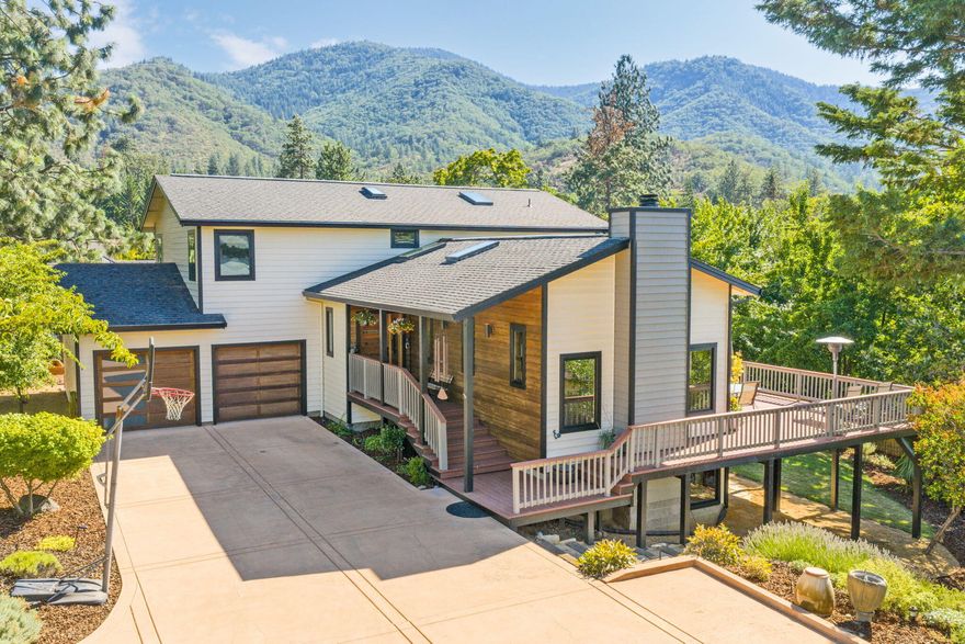 Welcome to this beautifully updated 5-bed, 3.5-bath home in one of Ashland's most desirable neighborhoods, just minutes from downtown. Thoughtfully designed across three levels, it blends generous living with intimate, inviting spaces. The main floor features a vaulted living room with fireplace and stunning territorial views, a true chef's kitchen with abundant storage and Bosch double oven, range. In addition, an elegant dining room, ½ bath and oversized two-car garage. Upstairs offers two spacious bedrooms and bathroom, plus the primary suite with serene views and spa-like en suite with heated tile floors. Opening onto a large backyard; the versatile lower level, with lounge/ bonus room, full bath, bedroom, and 5th bedroom/ office, could easily be self-contained and perfect for multi-generational living, guests, or an expansive work from home/ art studio space. Lovingly maintained, this home radiates warmth, quality, and charm, ready for its next chapter.