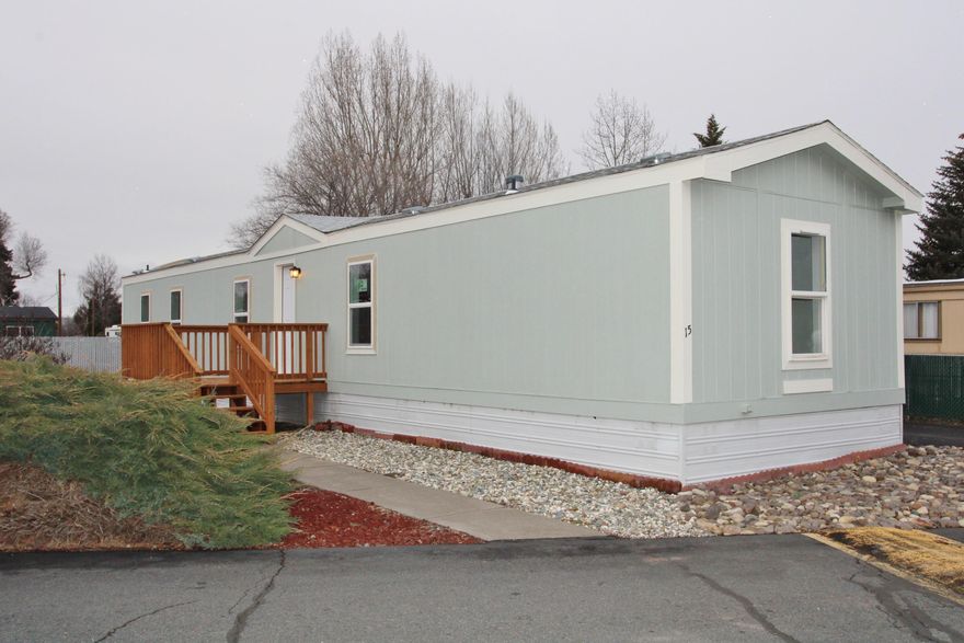 Wow, what's not new & easy ramp access too! Stunning remodel with beautiful new kitchen cabinets w/ pantry, brand-new appliances, sink & faucet, & handy portable island. Great primary bedroom w/wide entry door, walk -in closet, attractive barn door entry to primary bathroom, new walk-in shower, vanity, faucets, toilet & more. All new interior/exterior paint w/ open floor-plan, vaulted ceilings & attractive new flooring throughout. Brand new front deck, many newer vinyl windows, newer carport, handy storage building and a no maintenance lot in like new move-in condition. The furnace has been serviced & cleaned w/ 1 year home warranty provided as a gift to the buyer at closing. Located in the well-maintained 55+ community of Summers Lane Estates. Park approval required prior to offers.  Space rent includes water, sewer & garbage. The seller is completing exterior window trim paint prior to closing.