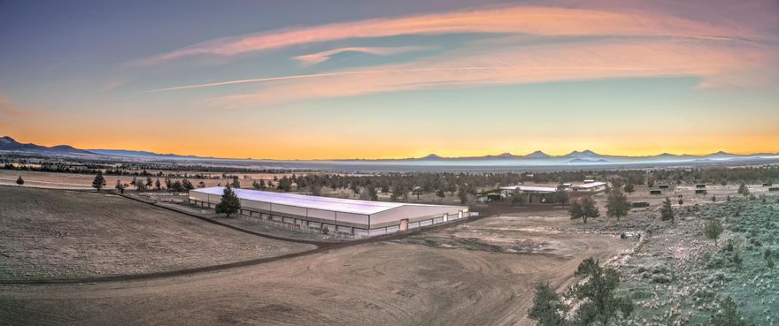 This first-class equestrian property, cattle ranch, & hay operation is located less than an hour from Bend. The ranch includes an impressive 81,600± square foot equestrian facility, a horse lover's dream! Complete with 117 horse stalls, two indoor arenas, an office, three large tack rooms, spectator judging areas,
a studio apartment, restrooms, built-in waterers, stainless steel stall fronts, concrete alleyways, & two wash rack facilities. In addition, there is an outdoor cutting arena, a heated mare barn with 36 stalls, several farm buildings, & 24 RV hook-ups. This ranch boasts excellent irrigated hay lands, with 311.3± acres of owned & leased water rights via 4
half pivots and 2 full pivots. This fertile ground has a history of producing top-quality alfalfa & hay. In addition to these fertile irrigated fields, there is plenty of rangeland pasture, including a small BLM pasture lease. There is a modest three-bedroom/two-bathroom historically been used as a farmhand dwelling.