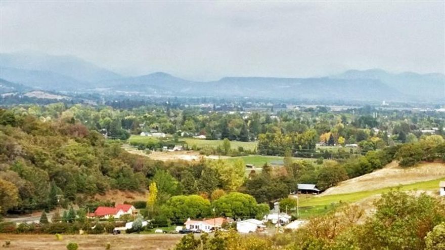 5 Gorgeous acres 2.5 miles from SMHS. Incredible views of Medford make this a must have location. Measure 49/37 allows this parcel to be split with a home on each parcel, to create two (2.5 acres parcels). Many opportunities exist with this rare piece. 30 gpm well plus possible TID. Power available at driveway. Two separate easements exist for access. In an area of high-end homes on private drive. Includes tax lots 1600 & 1700. You won't be disappointed.... Priced below market value