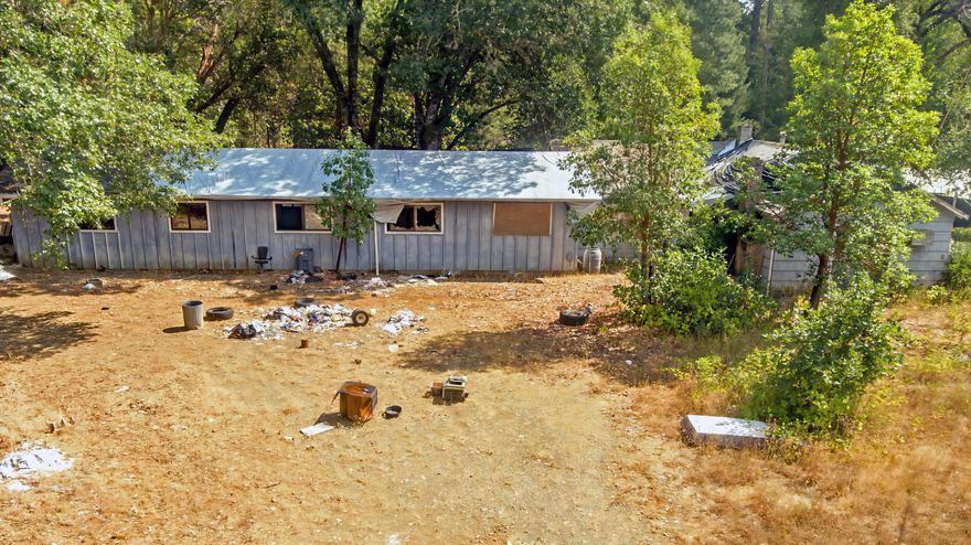 Your chance make a home your own
This spacious 2220 sq ft fixer-upper presents a unique opportunity to create your dream home. Boasting 4 bedrooms and 2 bathrooms, this property offers ample living space!

Situated on 2 beautiful, flat, and usable lots for a combined 3 acres; there's plenty of space for outdoor activities, gardening. The home needs renovation but it has immense potential, allowing you to personalize every detail to your taste and style.

Conveniently located just minutes from Cave Junction, you'll have easy access to local amenities and community services. For a wider range of options, Grants Pass is a mere 40-minute drive away, offering additional shopping, dining, and entertainment opportunities.

This is your chance to unleash your creativity and transform this promising property into the perfect place to call your own.