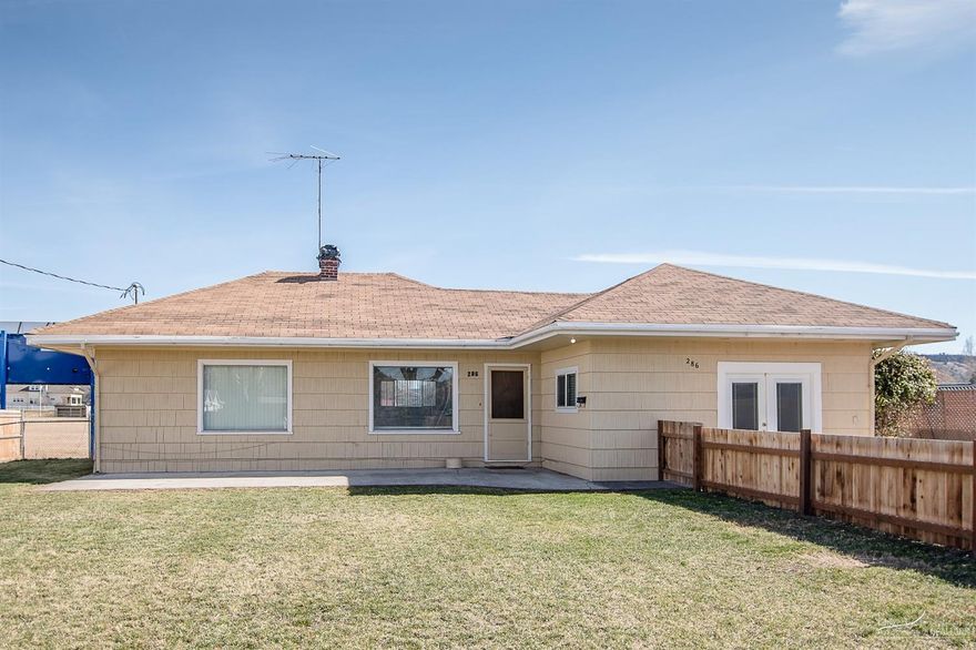 This is a charming, quaint house on a large lot and SO affordable!! Priced to sell! Beautiful Fenced yard with a ball field out back. 2 bedrooms with another room that could be used as a large Master or family room, Home has updated flooring and new fence close in town!! There is an easement in the back. This is a great investment opportunity or perfect first home!!