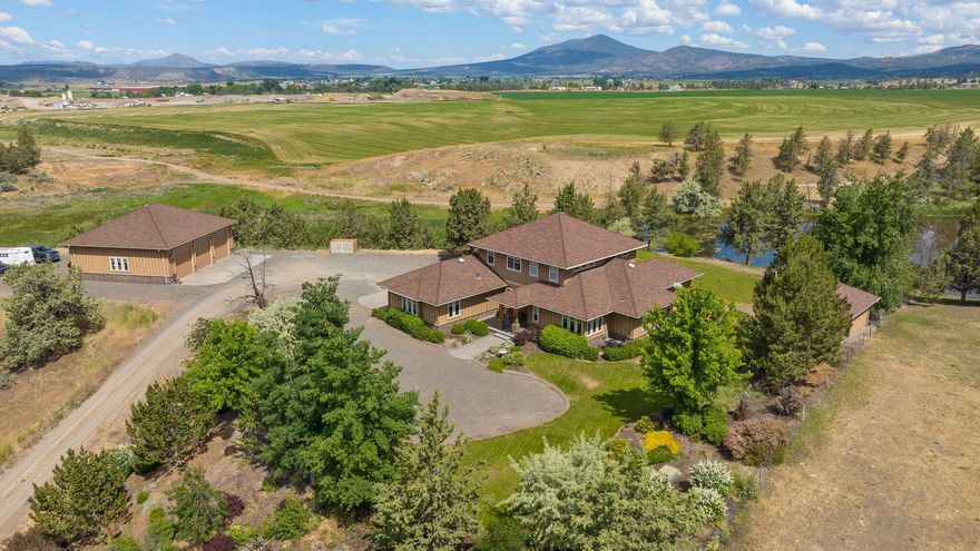 Country meets luxury & fine living! This beautiful property sits on 20.86 acres, 10.2 are irrigated, & offers everything you are looking for in small acreage. The custom built home features high end finishes, with plenty of space, amazing views, & outdoor living space. Located just minutes to town, with end of the road privacy, you won't need to sacrifice location for this amazing solitude. You will notice high end, quality finishes throughout. The marble counter tops, mahogany hardwood floors, cherry wood cabinets, high ceilings & doors, & large picture windows make this a refuge you'll want to enjoy. The kitchen features a large farmhouse sink, double convection oven, warming drawer, propane cooktop, island, & plenty of drawers & cabinets. The primary suite features a jetted soaking tub, dual sinks, tiled shower, walk in closet & large bedroom. Additional improvements include a 3 bay shop with bath, dog kennel, garden shed, & dock to the pond. Come enjoy solitude & country living.