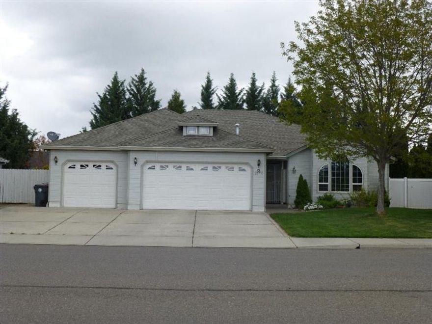 Must see this spacious well cared for home with quality craftsmanship throughout. Thoughtfully designed floor plan includes a formal living room with vaulted ceiling, arched windows, ceiling fan, gas fireplace with granite surround and wood mantle. Has a separate family room, a large kitchen featuring upgraded oak cabinetry, vaulted ceiling, hardwood floors, granite counters, appliance garage, wall oven, microwave, and island with gas cook top and prep sink. In addition you get an extra large .29 acre corner lot, covered deck, back patio and large fenced back yard. Wait there's more! Included is a 3 car garage plus RV parking with hook ups and extra storage in attic. Located close to schools, shopping, and entertainment. Convenient freeway access. Seller motivated.