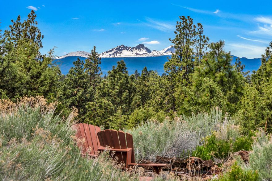 Very rare opportunity to own a large flat .54 acre lot with impressive mountain & river views right in the center of town near the Old Mill District. A little slice of paradise in one of Bend's best-kept secret locations. This private property is nestled on the outside edge of a horseshoe peninsula & has sweeping views of the Cascades, from Mt. Bachelor to Pilot Butte, the Deschutes River & Old Mill District. Single level home with Mid-Century Modern accents, floor to ceiling fireplace & large picture windows. Kitchen opens to a courtyard ideal for entertaining. Three beds, two baths & sunroom. Upgraded accents include quality wood doors, engineered flooring & decorative tile. Park-like setting with gardens, rock outcroppings & gorgeous skies from sunrise to sunset. Neatly protected by a quality fence that encapsulates the property. Enjoy as-is, or turn into your next dream home. There are 2 TAX LOTS, so you could buy this & simply enjoy the extra space or create your dream compound!