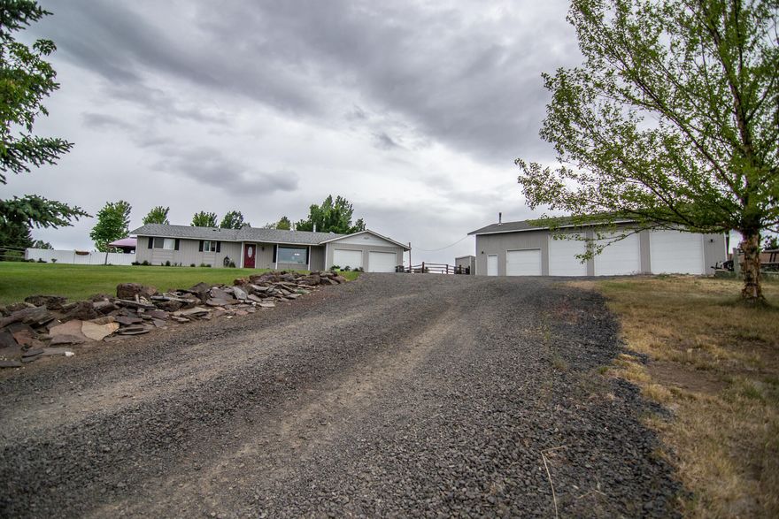 The small Country Estate that you have been looking for is now available. This 1.78 irrigated dream property boasts a remolded 3-bedroom 2-bath home with incredible open farm country views. The sunken living room with a new pellet stove opens to a new kitchen with hickory cabinets and new appliances. The kitchen then flows to a large open family room with loft, great for entertaining. The bedrooms are located off the sunken living room giving a sense of separation. The primary bedroom has a beautiful new bathroom with large tile shower. A outside door was added off the Primary Bedroom to a private hot tub. Sit in the hot tub, get lost in thought while gazing at the beautiful scenery or the evening stars all while thinking I'm home. Wait, there's more. An amazing huge 4 bay 60 x 30 shop with approximately 13 foot ceiling and if that wasn't enough there's an additional 60 x 12 roofed lean to on the backside for additional storage of toys or equipment. Don't miss out.