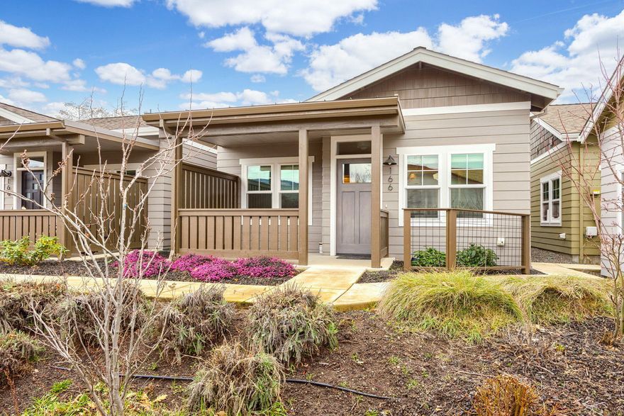 Part of Ashland Garden Cottages and beautifully designed for sustainable living, distinctive cottage homes include drought-tolerant plantings, pollinator garden and community open space.  The home faces the interior courtyard area for quiet.  Homes are Earth Advantage Platinum, Zero energy, and Lifelong Housing certified and includes solar panels.  This model is a semi-detached plan featuring covered porch, resilient plank flooring, quartz countertops, custom stained cabinetry, Energy Star appliances, tile shower and flooring and designer lighting.  Very comfortable and well-designed bedrooms, one with screened door.  Attic storage area with unique pull-down stairs. This home offers an efficient layout, updated features and low maintenance costs.  Convenient to the Plaza, dog park and Bear Creek Greenway.