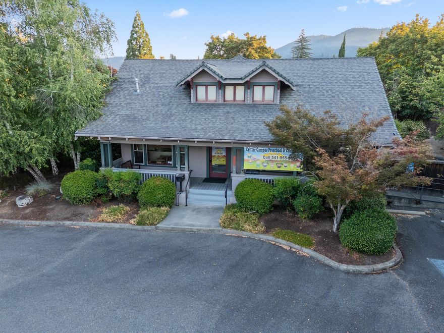 Great location for Office/Medical on well-traveled A St in Grants Pass. This ca. 1900 residence has undergone multiple adaptive reuses, previously converted to office use, and most recently used as a licensed day-care facility. Features include a designated reception area, several offices/rooms, a downstairs bathroom, and a functional upstairs with a second bathroom and multiple rooms that may serve as offices or additional program space. There is also an outside back deck with stairs leading to yard and a welcoming front porch. The property sits on nearly half acre lot with paved parking with room for expansion. Located in a predominantly residential area along a major thoroughfare supporting office/medical/daycare, the site is within close proximity to both an elementary and a high school, supporting its continued use for childcare or other neighborhood-serving functions. The current lease expires March 31, 2026. Renew lease at market rent or owner occupy.
