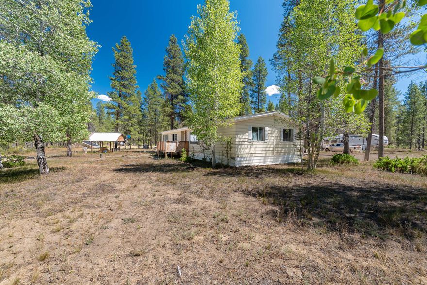 This 7.91-acre unique property features a remodeled 3/2 set up for multi-generational living. Additional homesite with full hookups in place to build dream home. The heated underground greenhouse for year-round growing, dedicated yoga hut, and a Hipcamp-style guest area perfect for outdoor recreation or hosting. Nearly 8 acres of homesteading opportunities. There are two potential driveway access points, one on Midstate and one on Kurtz, providing flexibility for future development. The original foundation includes full electric and sewer hookups, offering the option to build a new home, shop, or studio. New well was installed in 2021. The large garage/shop provides ample space for storage or workspace, and horse stalls are in place for equestrian use. With plenty of room for gardens, livestock, and expansion, this is a unique opportunity to own an adaptable property with infrastructure in place for sustainable living and creative possibilities. Perimeter of property is fenced