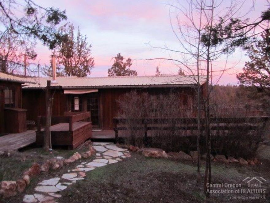 This rustic cutie won't last long! Featuring 3 bedrooms, 2 baths, wrap around deck, woodstove, vaulted ceilings, detached double car garage and studio/shop. Home has great potential!