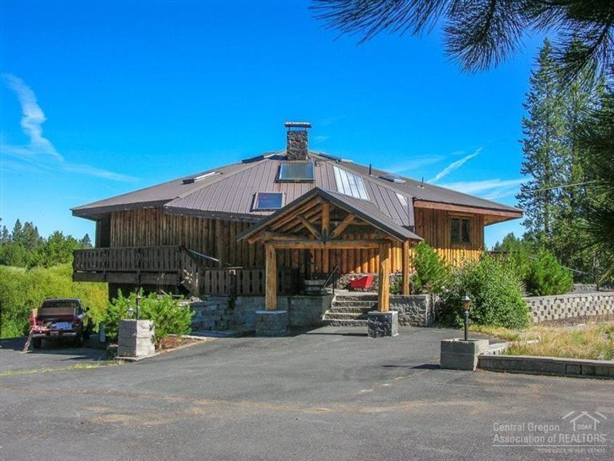 Sunriver Area Log/Frame Home on 2.26 Acres on the River! This one-of-a-kind riverfront home offers: great room w/soaring vaulted ceiling, extensive Blue-Pine accents, skylights, floor to ceiling stone hearth & pellet stove, front family room w/bar & spectacular river views, elevator/dumb waiter, open kitchen/big dining area w/B-bar, main level master w/tiled bath & walk-in, 500ft of river frontage + dock, big shop + log building, green house, large paved drive & parking w/security gates, 1 yr home warranty!