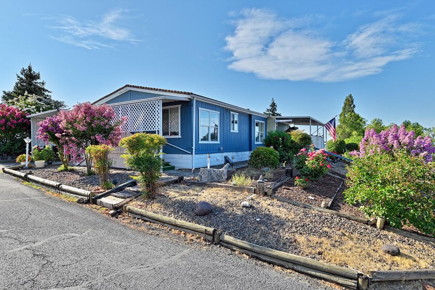 Enjoy breathtaking panoramic views of Mt. McLoughlin and Roxy Ann from the comfort of your covered porch. This beautifully maintained 3-bedroom, 2-bathroom home offers 1,431 sq ft of comfortable living in the desirable Western Carriage Estates 55+ community. The home features a sought-after split floor plan with vaulted ceilings and a spacious living room that flows seamlessly into the dining area. The kitchen is bright and inviting, featuring a skylight, a breakfast nook, and ample cabinetry. The generously sized primary bedroom offers a peaceful retreat, and laminate flooring is featured throughout for easy maintenance. Recent updates include fresh interior and exterior paint, a newer water heater, a water softener, and an upgraded HVAC system. Step outside to enjoy a beautifully landscaped, low-maintenance yard—perfect for relaxing or entertaining.