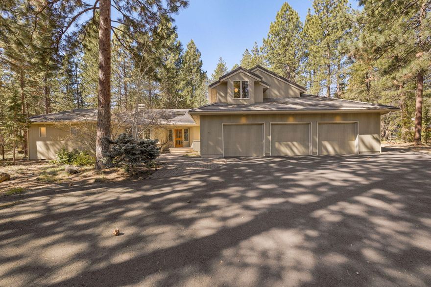 Nestled in the coveted Sunrise Village neighborhood, this home is ideal for exploring nature right outside your door. Living like a single level with a private primary suite on the main floor, the high ceilings of the great room continue throughout the open floorplan filling the home with natural light. The kitchen is enhanced by extended counter height seating and an overheight architectural window looking out to the private backyard and expansive ground level deck. An additional main floor bedroom and bathroom are on the opposite side of the home, with a third bedroom and bathroom integrated into an upstairs bonus living area. Oversized 3-car garage includes room for a workbench, attic storage, as well as a partially covered and fenced exterior area providing flexible options for gear. Neighborhood amenities include community pool, tennis courts and dog-walking trails with private access to the Deschutes River.