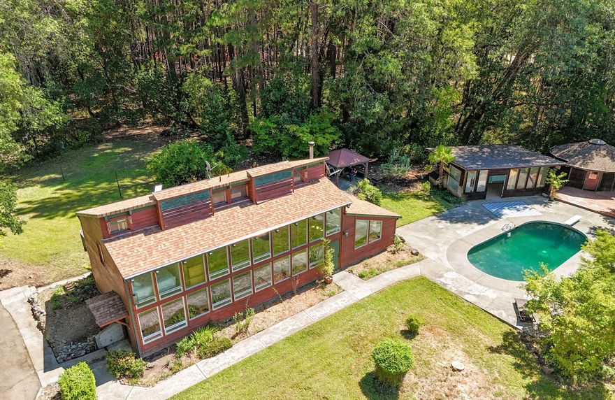 Looking for that country living that has it ALL-the house, land, shop, pool, yurt & more? Built in 1979, w a focus on energy-efficiency & quality craftsmanship; this unique home was 1 of 10 winners in Oregon for the ''First Passive Solar Residential Design'' competition. The passive solar system allows the warm sun to naturally heat 1988 sqft of 3 bedrooms, 2 baths, 2 living areas, dining, kitchen, office/nook area, & large laundry room. Good producing well to grow your abundant garden while harvesting from the mature orchard of existing pear, apple & plum trees on 6.92 EFU acres. Cook it up in the beautiful kitchen w granite countertops, 6 burner stove, stainless steel fridge, island w original butcher block, custom cabinets, cherry hardwood floors, updated bathroom vanities, & plenty of storage space. Privately secluded for you to reset w stunning mountain views, pool, sauna, & yurt to take a timeout & clear your mind.  Detached outbuildings & carport for all your storage needs.
