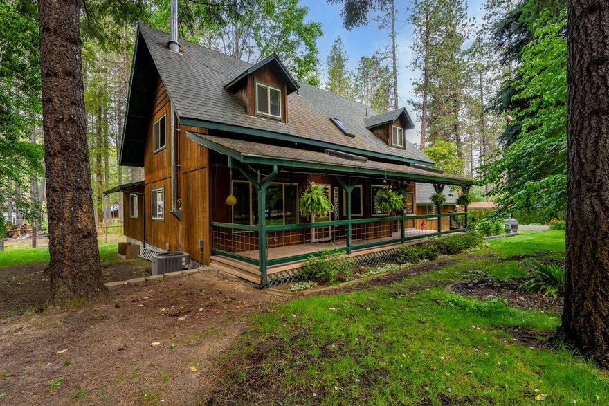 Nestled on 1.5 acres of maintained, park-like grounds, this spacious 4 bedroom, 3 bath home offers 1,968 sq. ft. of living space with a blend of privacy, functionality, and charm! The open floor plan of the 1st story contains the kitchen, dining area, and large living room with a wood stove. The primary bedroom en-suite, laundry, and guest bathroom are also located on the 1st story. Upstairs you'll find 3 more bedrooms and another full bath. The covered front porch is a great place to enjoy the mature trees, lush lawn, and curated landscape that creates the park-like setting. The back deck is a great relaxation area with the included hot tub. Animal owners will appreciate the barn and fenced area that is great for horses, cows, etc.. Attached 2 car garage. The property contains a good size chicken coop, storage shed, tree-fort, and pumphouse. Fenced and gated from the road. This property offers rural living and convenience with being just over 5 minutes to the town of Rogue River!