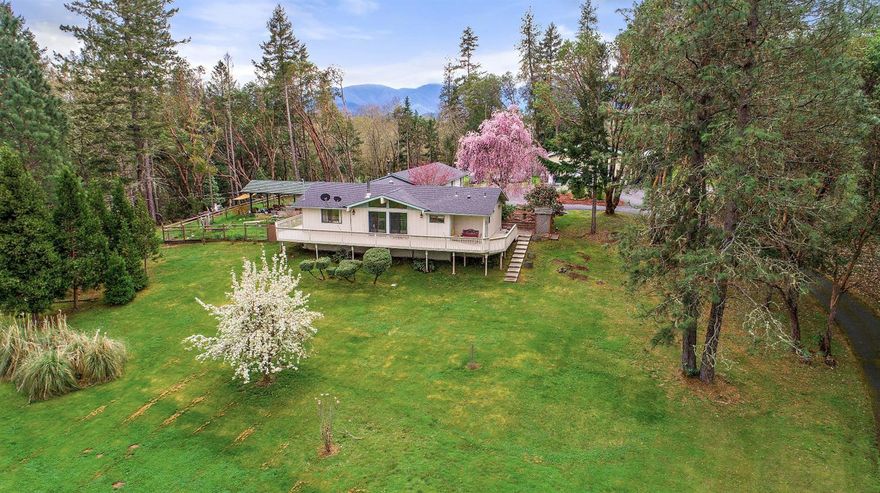 Charming ranch house on 4.98 pristine acres. Beautiful mature trees accent the property. An elevated deck overlooks green pastures. Amidst the backyard patio and garden stands a large pergola for outdoor entertaining and dining. Two certified wood stoves keep heating bills to a minimum. Remodeled in 2002, an oversized 2-car garage was added. Plenty of beds for the avid gardener and for the handyman there is an amazing 40 X 40 shop. Close to the Rogue River for fishing and boating, this is a must see!