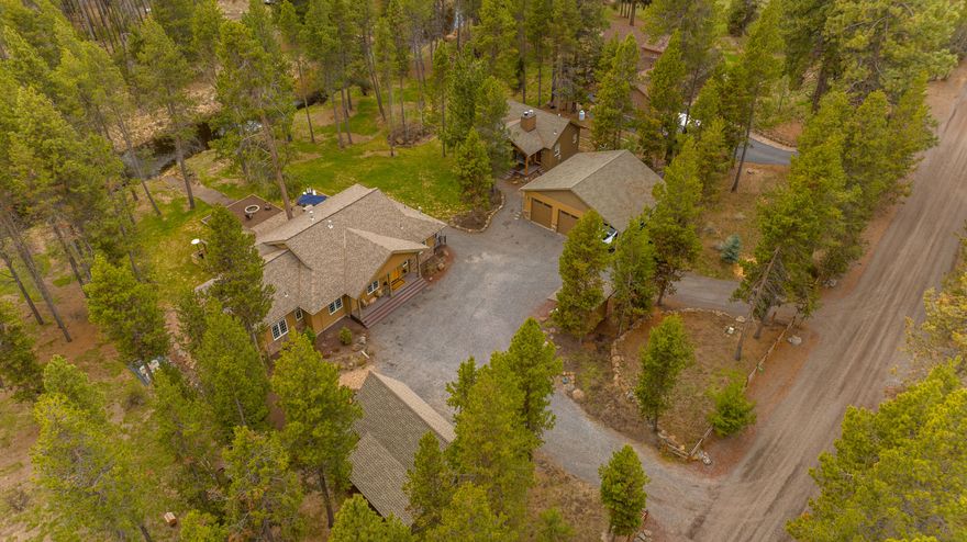 Four miles from the heart of Sunriver & 15 miles from Bend, this custom home rests on 1 acre backing the canal of the Deschutes river. Single level, featuring 3 bedrooms, 2.5 bathrooms & a true office with 10' ceilings throughout. The kitchen, with its stainless steel appliances, granite counters & hickory cabinets is sure to delight any home chef. A spacious primary suite includes dual vanities, full tile shower & jetted tub making a luxurious retreat. The detached 600 SF guest quarters features a full bath & kitchenette providing a great option for hosting guests or rental income. The finished heated 560 SF shop with two 10' doors offers all the storage needed. Plus, an additional 2 car garage with gravel floor & stand-alone chicken coop. Entertain & relax on the paver patio with pergola & fire pit surrounded by the park like setting. Road is maintained by the county & the $50/yr. HOA maintains nearby private boat ramp & park. This home exemplifies Central Oregon living.