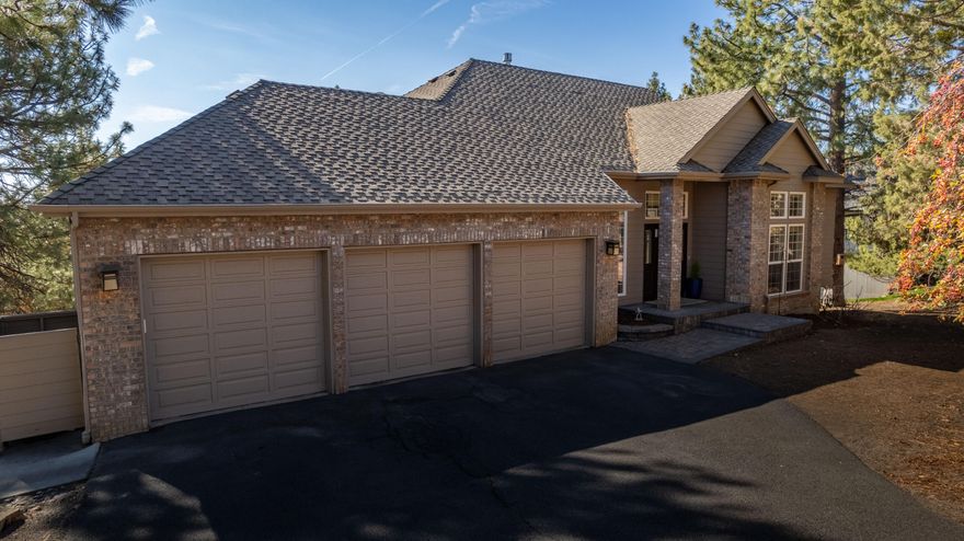 Situated on a private .85-acre lot on one of Awbrey Butte's most coveted streets, this 4 bedroom custom home in NW Bend is an exceptional value! As you step inside, you're immediately drawn to the floor-to-ceiling windows flooding the room with natural light. There's easy access to the south facing deck from both the living room and kitchen, a perfect place to enjoy the city and tree top views. The main level also features the primary ensuite, complete with a freestanding tub, a walk-in shower, dual vanity, and a large walk-in closet. The kitchen is well-appointed with high-quality appliances including double wall ovens and lots of storage.  Downstairs, you'll find three generous guest rooms, a full bathroom, the utility room, and a bonus room that leads out to the lower patio and backyard space—perfect for entertaining or enjoying the outdoors. The home also has a heated driveway and a big 3-car garage. Live the Bend dream in this beautiful home by summer.