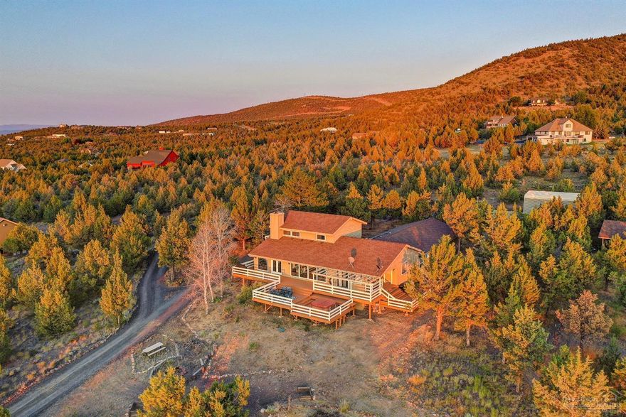 Gorgeous updates & stunning views on 5 acres in desirable Red Cloud Ranch! Owners put so much love and work into remodeling this home! Fabulous open stairwell entry leads to completely redone kitchen. Barn doors slide open to huge pantry, brand new appliances, corner sink with views of Powell Butte, granite counters, breakfast bar and so much more...Two living areas with panoramic views of Smith rock and Mountains. Expansive decking with hot tub perfect for entertaining. Main floor has 3 bedrooms, two full bathrooms and laundry. The big bedroom could function as a master w/french doors out to deck and Walk in closet. Upstairs is loft, master suite and balcony. Do not miss the enormous 728 sq. foot bonus room w/separate basement access under the deck! Outside is a darling playhouse and outbuilding for animals. New paint, windows, carpet, and septic in 2017 (pumped in 2019) plus RV carport new in 2018. Please see 3D walk thru!