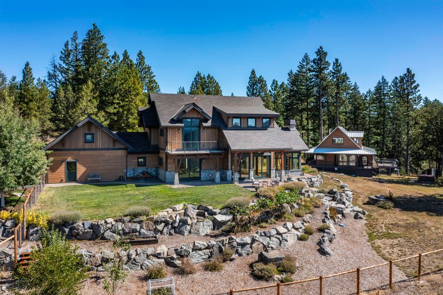 Exceptionally rare family estate or retreat property with two homes on 100+ private acres - including the Green Springs Summit - adjacent to the Cascade-Siskiyou National Monument, just 18 miles from downtown Ashland! Expansive panoramic views of Mt Ashland, Pilot Rock, and Hobart Bluff. New home with Earth Advantage Platinum certification, high vaulted ceilings, exposed timber beams, walls of windows, main-level primary with full ensuite bath and walk-in closet, paver patios, kitchen with leathered granite counters and custom Alder cabinets, powder room, laundry mudroom, spacious media loft, two guest bedrooms, full guest bath, bonus room, and two-car garage. Original home with wrap-around covered porch, kitchen, living and dining areas, main level bedroom, full bath, two upper-level bedrooms with skylights, and half-bath. RV barn, greenhouse, two solar arrays, and potential additional homesites. Vibrant and welcoming mountain community from all walks of life. Inquire for details!