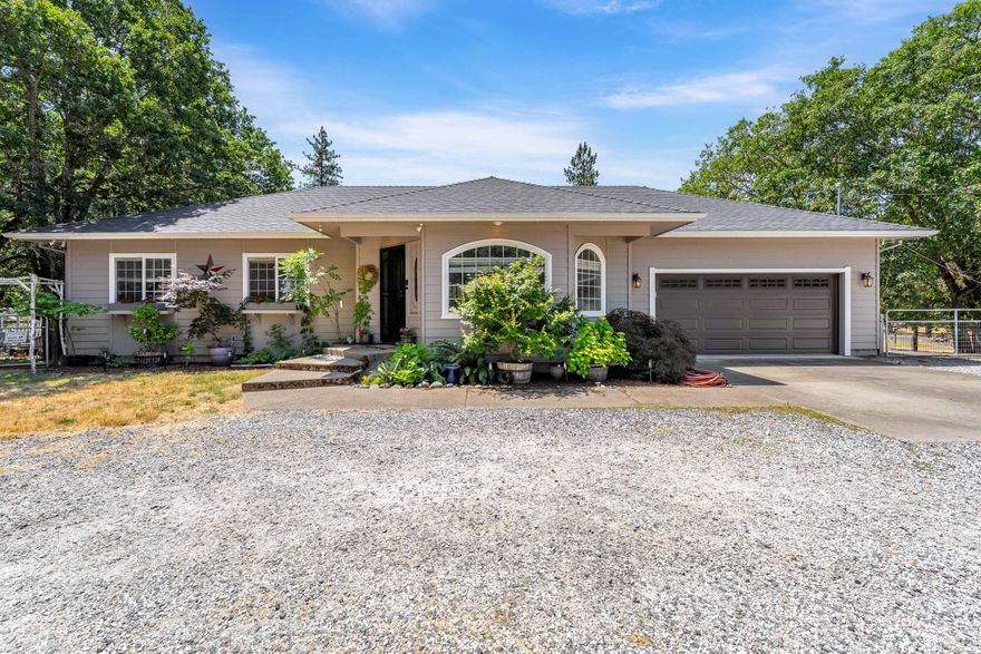 Modern comfort meets country charm in this beautifully updated single-level home with a bright, open layout, vaulted ceilings, and LVP flooring throughout. Large living that flows into dining and kitchen. The kitchen has recent updates including refinished cabinets, granite and ss appliances. The primary bedroom is a true retreat with access to the covered deck, walk-in closet, and fully updated bathroom including tile floors, tile shower, and new vanity. There are 2 more bedrooms and another fully updated bathroom. Enjoy the outdoors with a covered deck, fire pit, above-ground pool, chicken coop, fenced garden, and greenhouse. The 2-car garage includes a bonus room ideal for a home office, gym, or extra storage. A circle driveway offers plenty of parking and easy access. The property is fully fenced, cross-fenced and offers extra security with an electric gate. All located on a peaceful, usable 1.37ac property with great proximity to the I-5. Come explore the possibilities!