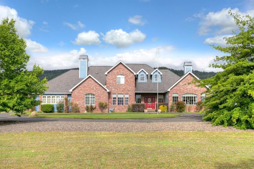 Stately 5,188 sq. ft. English Manor style home w/ valley & mtn. views in the West Hills area just outside of Jacksonville on 2.98 acres. Dramatic views & light-filled 2-story home w/ soaring ceilings, 4 bedrooms, 4-1/2 baths, formal living & dining rooms, inviting family room w/ huge brick hearth & woodstove. The kitchen, w/ great views & easy access to pool, offers spacious island w/ bar sink, double ovens, endless storage, stainless appliances & informal eating area. Main level master suite offers sitting area w/ fireplace, separate office w/ built-ins, master bath w/ dual vanities, soaking tub, walk-in shower, & huge walk in closet. 2 family set-up or spacious guest wing w/ 2 additional bedrooms, open LR & kitchen, bath, & separate laundry. Gated entry, fencing, in-ground pool, oversized 2 car attached garage, & separate detached garage/workshop. Additional 2.69 acre separate buildable lot for sale (see mls #2965530).