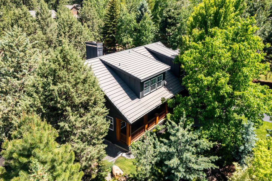 Extensively remodeled westside Bend oasis in the trees! Gorgeous & fully updated, this exceptionally private home is nicely appointed on a quiet cul-de-sac & oversized lot, backing to common area & at the base of the Haul Trail. Light & bright, stunning new kitchen w/large island, 6 burner range/cooktop, quartz counters & backsplash, drawer microwave & beverage fridge. Beautiful floor to ceiling black brick fireplace surround & gas fireplace, modern railing, refinished & extended maple hardwood throughout, new hallway built-ins & laundry room w/herringbone tile. New int & ext paint, carpet, lights. Primary on the main w/radiant floor heat in bath  + office/den. Additional 2 bedrooms & large bonus (or 4th BR) up. Surrounded by mature trees, landscaping & abundant wildlife. Enjoy happy hour on the deck or a nice soak in the hot tub after a day at Bachelor. Just steps to the Haul Trail & Deschutes River Trail, Athletic Club, Old Mill District and Downtown Bend. Live the Bend dream!