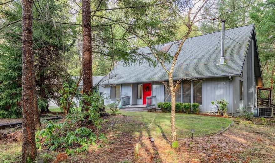 Privately tucked into a 2.51 acre lot with privacy from the road is this 3 bdrm, 2 bath, with separate office and add'l approx. 16x14 loft area. Unusual, one of a kind, special & unique are all words to describe this home. Upon entering you're awed with the metal staircase that leads to upper level loft area that overlooks living room. A unique landing area in the center of lower level separates the living room/kitchen area from the office and master bedroom/bath. Open floor plan with very high ceilings, woodstove and lots of windows that create a feel of a tree house. Upper level loft could be an artist studio , exercise, home office or kids play area...lots of options approx. Two bedrooms/bath upper level. Large deck, two car detached garage and RV covered parking . Very natural setting with low maintenance . Extra's include pull out drawers in kitchen, skylite, step down living room, A one of a kind home that could be decorated to meet your needs. Call for your showing !