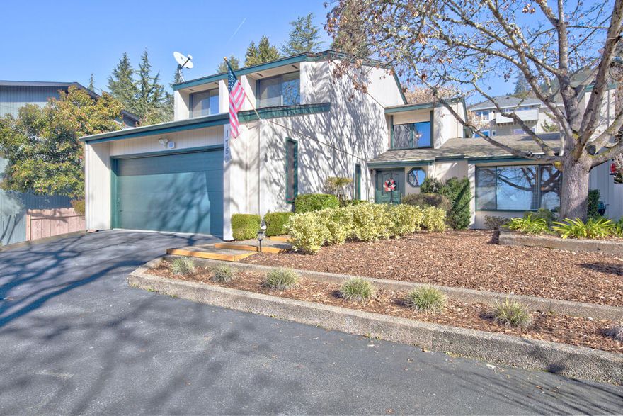 Beautifully maintained 3 bedroom 2 1/2 bath in a great location, near city center and all of the services that Grants Pass provides.  With all new flooring and entire interior painted in 2019, this home has a formal living area with wood fireplace, beautiful formal dining room, a spacious eat-in kitchen with breakfast bar, plus a large family room with access to patio and a very private and thoughtfully landscaped park-like backyard. The upper level has a split floor plan with two full baths and lots of storage. The laundry room with brand new washer & dryer, is perfectly situated off the finished oversized 2-car garage.  Property has  2 extra off-street parking spaces. The home is located in a neighborhood of stunning homes with amazing views and it is a decorator's dream. Seller is offering a one-year home warranty. Come and view this unique and lovingly cared for home. It will not disappoint.  BETTER THAN THE PICTURES!