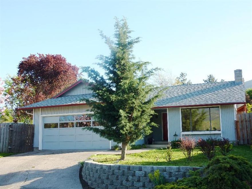 Nicely updated cottage style home in the heart of Ashland. Located on a cul-de-sac with views of the surrounding mountains, this single level home is close to schools and shopping and walking distance to the downtown plaza and Lithia Park. Laminate entry, brick fireplace in the living room, galley style kitchen with new stainless range/oven and dishwasher, wall pantry, built-in desk area and new slider to covered patio. Updated baths, new interior paint and carpet, new light fixtures, double pane windows, new composition roof, newer hot water heater, new natural gas HVAC in 2011, some new exterior paint and great storage. Situated on a .17 acre lot, fully fenced with mature landscaping and room for all of your gardening plans, this cottage is move in ready and waiting for you to call this home.