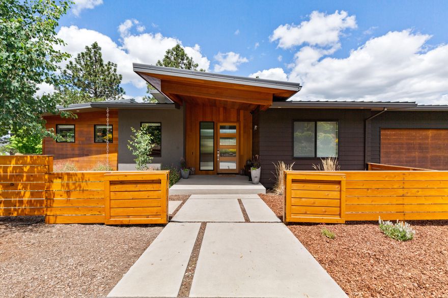 This stunning modern designed home provides expansive views all the way to Table Rock. Primarily main level living that you desire. Two additional bedrooms, a family room, and a bonus room on the lower level make this home both functional and stylish. The fusion of wood, steel, stone, and concrete create wonderful living spaces. Towering 14 foot ceiling in the great room that is surrounded by windows on all four walls. Stunning 8 foot mahogany doors throughout the home. You will love the cook's kitchen with the quartz island, 36' gas range and additional separate convection oven. The clear cedar accent wall is the perfect look to complete this kitchen. The primary suite offers a ceramic soaking tub, radiant heated tile floors, and a roll in shower. Two decks to utilize. One deck accessed from the great room and the other from the kitchen. The electronically controlled transom windows give this home wonderful passive cooling and air flow. You are going to love this home.