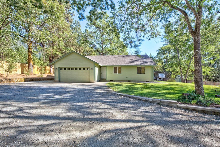 Built in 2010, this fantastic Home & Property has everything you need! The 1,181 sq. ft home is set back from the road on a fully fenced 1.09 acre lot and features 3 bedrooms & 2 bathrooms. Kitchen has generous amount of shelves & cabinets with slide outs, as well as all Appliances. Newer waterproof laminate flooring in living areas & bedrooms. Master bedroom has spacious walk in closet. Sliding door from living room extends your living space outdoors with a covered patio and plenty of backyard to enjoy. In addition to an attached finished two car garage, there's also a spacious shop with shelving & concrete floors. Sprinkler system in front and back, new well pump in July 2018. Pad and Covered RV Parking in back, as well as storage for boat or other toys on side of house.  Additional storage building with metal roof and loft. All this space and country feel, yet only minutes to town. This Home is well kept and won't last long in this market. Make your appointment to view today!