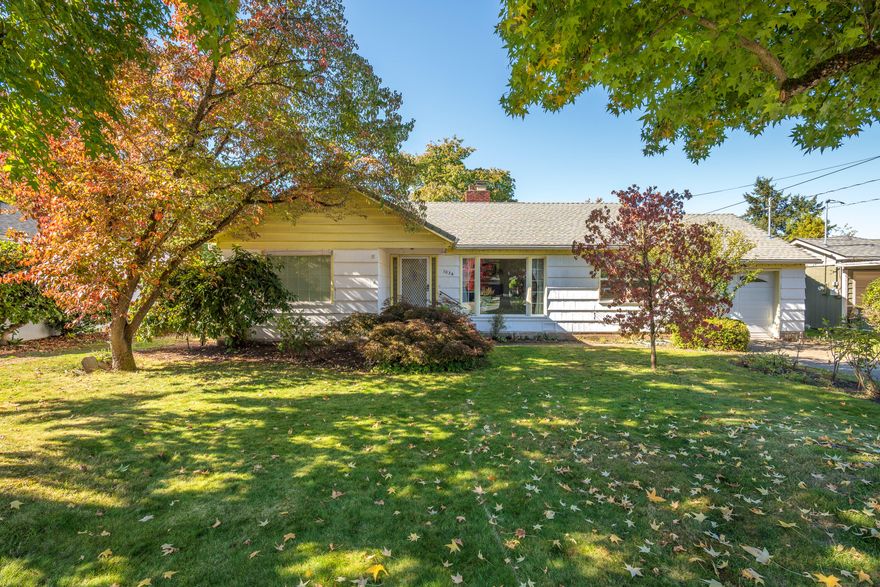 Charming 3-bedroom, 2-bath home in a highly desirable neighborhood close to shopping, medical, parks, and schools. Looking for a peaceful walkable neighborhood?  This may be it!   The welcoming front porch opens to a spacious living room and an updated kitchen. Two bedrooms feature beautiful original hardwood floors and share a full bath, while the third oversized bedroom is conveniently located near a second bath. You'll love the abundant storage throughout the home. Step outside to the expansive covered back porch overlooking a stunning backyard filled with mature fruit trees, berry vines, grapevines, and plenty of space for your dream garden. A rare blend of character, comfort, and outdoor beauty — this one feels like home.