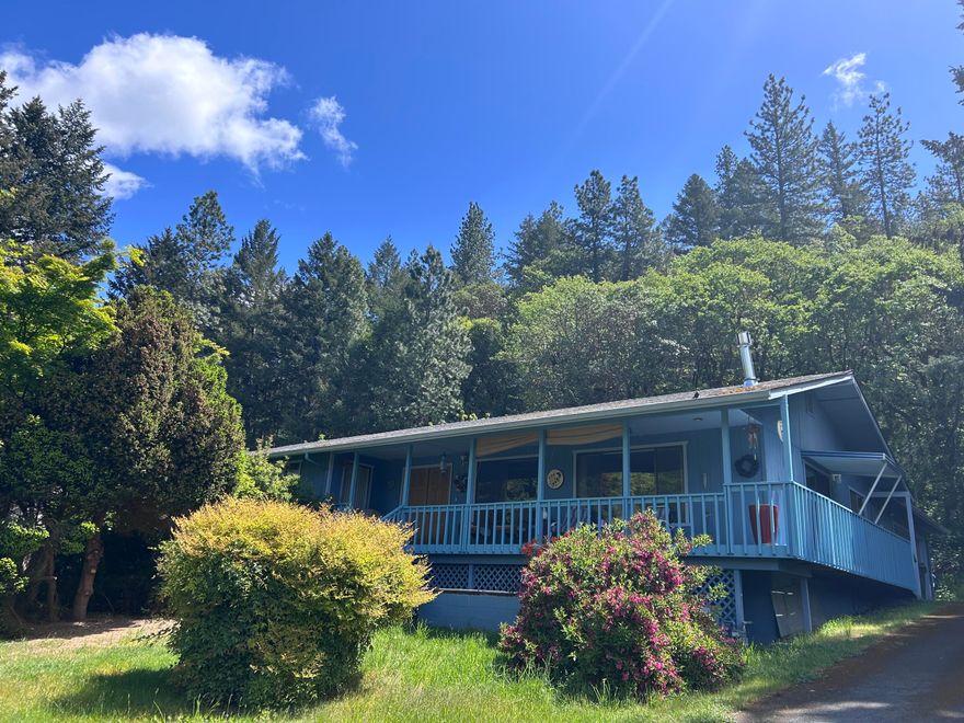 Come take a tour of this charming home with Rogue River views & access to it just a short walk across the street to the river. Great fishing, part of the property is across the street to the river. The covered front porch has beautiful views of the mountains & river. It was recently painted. Back yard is fenced in with a carport. Lots of privacy in the back. There is a shop & 2 car garage. Bedrooms our very specious. Views from the living room & dinning room. Granite counter tops in the kitchen and plenty of cabinets for storage. There is a ramp entry to the front porch also. Centrally located between Grants Pass 11 miles & Rogue River 4 mins away, plus I-5 Freeway North or South access 4 min. away, MOTIVATED SELLER!