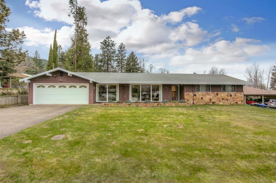 This house is a 1968 classic: ranch style, desirable neighborhood on a spacious, flat .68 acre lot with T.I.D irrigation, zoned R-1-7.5. Other features include large picture windows, 1726 square feet with 3 beds & 2 baths. The layout works well for either a couple or a family with plenty separate spaces to enjoy: large kitchen, formal dining and a large living room/family room. Additionally we have an over sized 2 car garage, a laundry room, an additional mud /storage room to come in and out the back yard. The home was solidly built by the current owner and impeccably maintained by him since then. Step out the dining room doors to a sizable Port Orford Cedar deck which looks over the back yard where a magnificent blue spruce tree presides. At the rear of the property is Clay Creek, which runs year round. A classic house with views, in a beautiful neighborhood. Close to town & trails. This spacious lot has may possibilities, buyer to due own diligence.